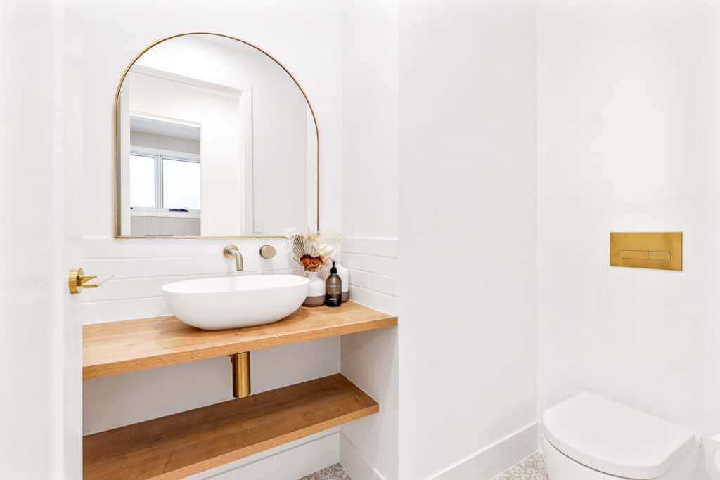 Powder room vanity with arched mirror