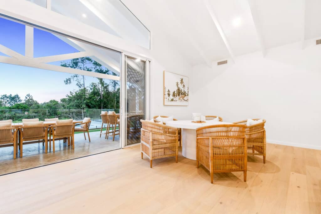 Dining room opening to the pool and alfresco in a FEZ custom home