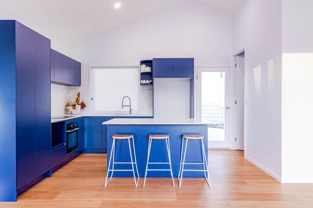 Navy kitchen with timber floors