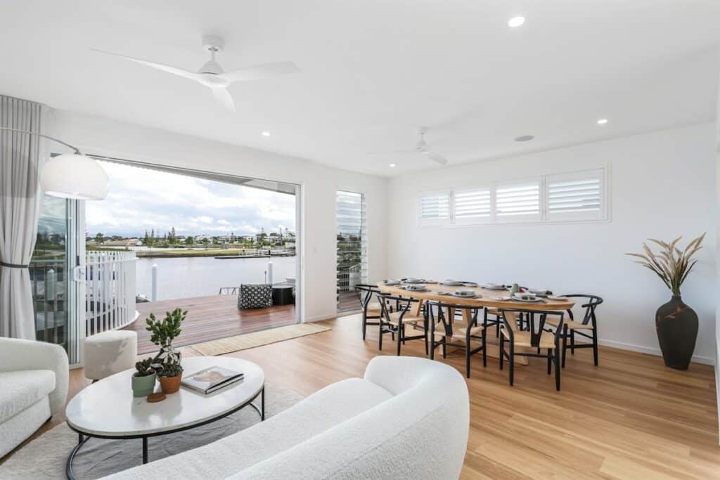 Living room opening to a water view