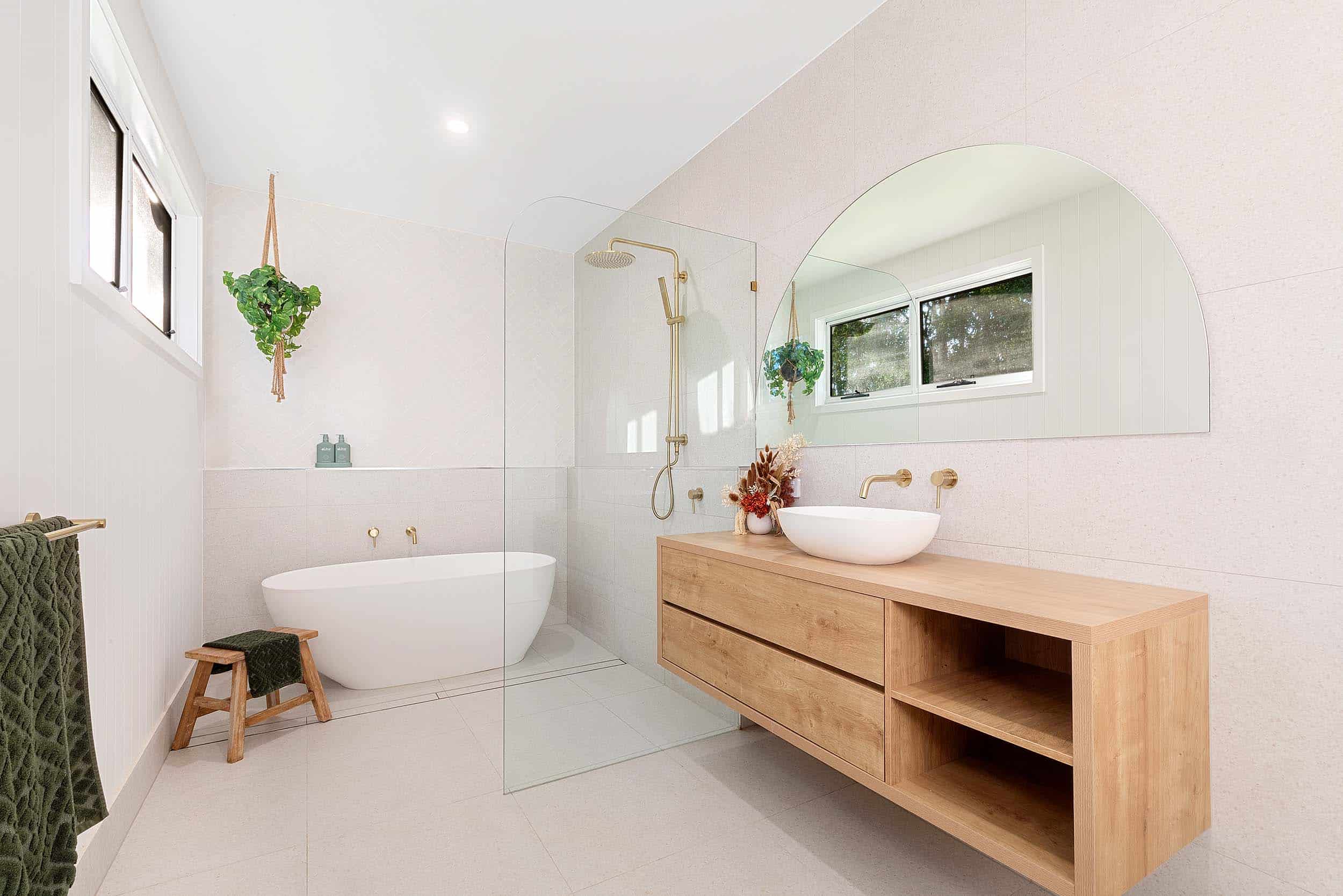 Bathroom with freestanding bath, timber vanity and textured white tiles